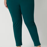 A good workwear pant for plus size women, this is a close up of a green tapered leg pant is shown on a size 18 woman. Worn with summer top women in printed jersey, these ankle length pants wear for work and casual wear. Trousers with stretch, Australia and New Zealand women's clothes label Leina & Fleur specialise in comfortable workwear for women in sizes 8 to 24.