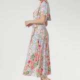 An elegant V-neck with a functional tie front, flared sleeves with subtle slits, and softly gathered detailing add feminine charm and graceful flow.