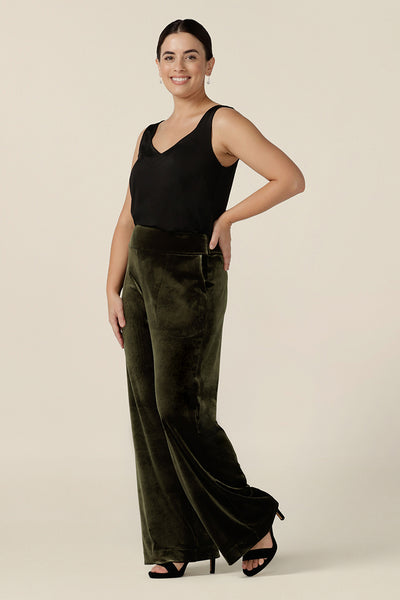 Good cocktail pants for petite women, the Deni Pants are straight, wide leg pants in green velour and are shown with a black cami top. These evening trousers are pull on pants and comfortable in stretch fabric. Shop petite to plus size occasion and cocktail attire online at Australian fashion brand, Leina & Fleur.