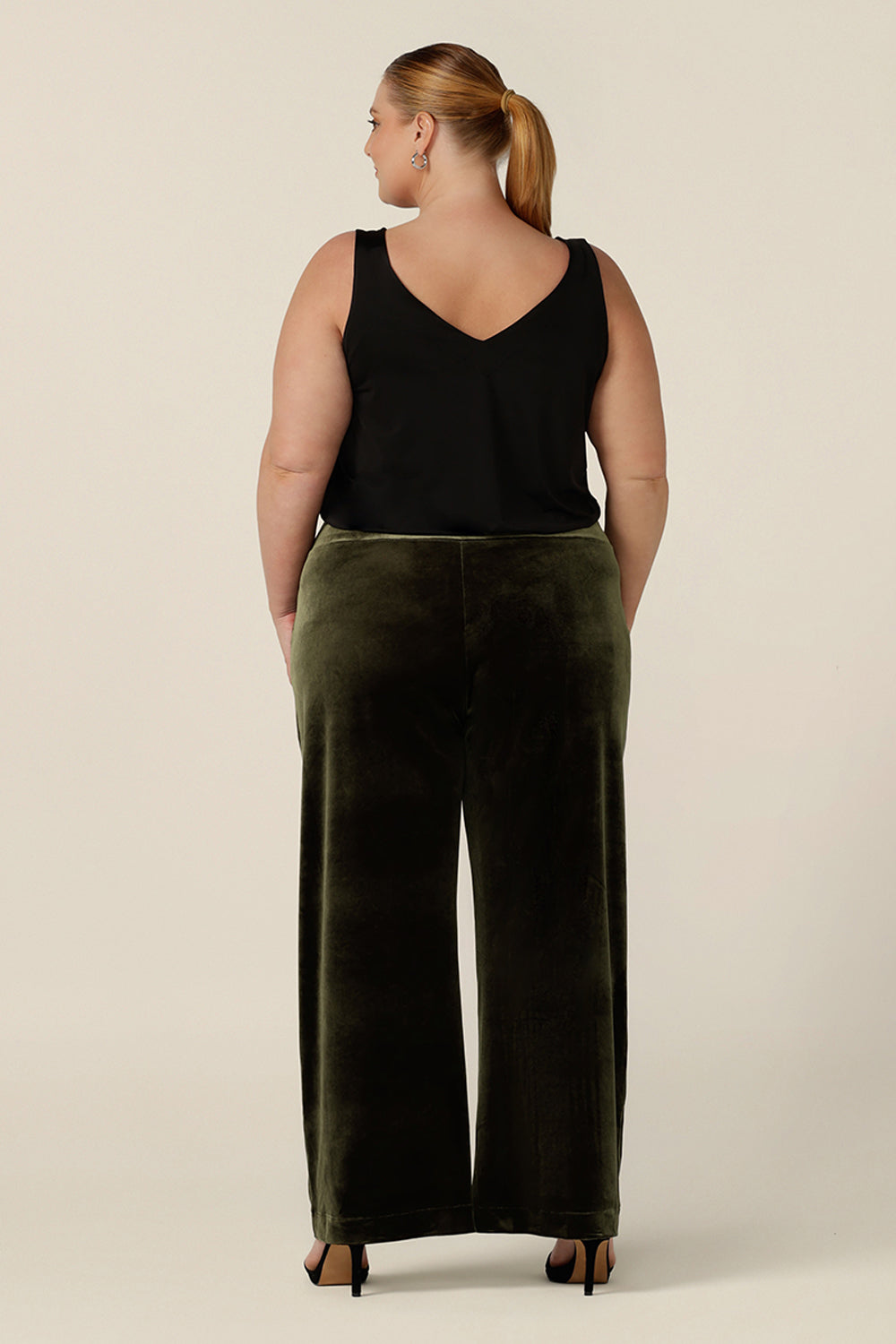 Back view of good cocktail pants for plus size women, the Deni Pants are straight, wide leg pants in green velour. These evening trousers are pull on pants and comfortable in stretch fabric. Shop this occasion and cocktail attire online at Australian fashion brand, Leina & Fleur.