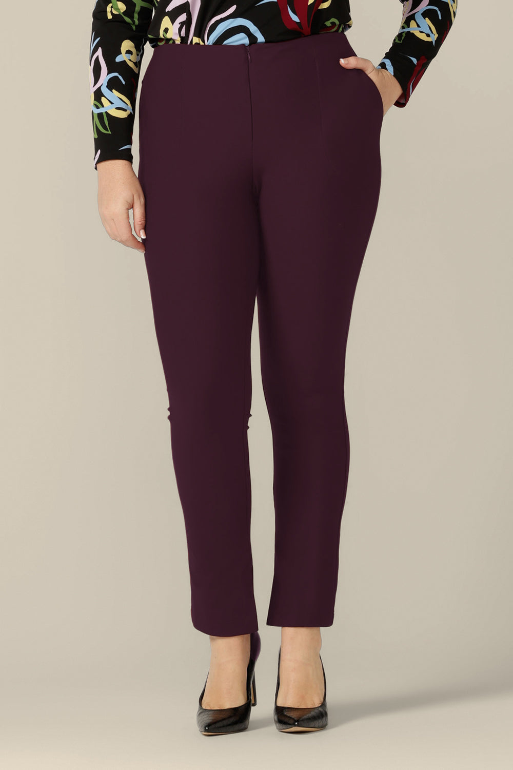 A size 12 woman wears slim leg pants in mulberry ponte jersey by Australia and New Zealand women's clothing brand, L&F. Good pants for work, these comfortable trousers are made for an inclusive size range of sizes 8 to 24.