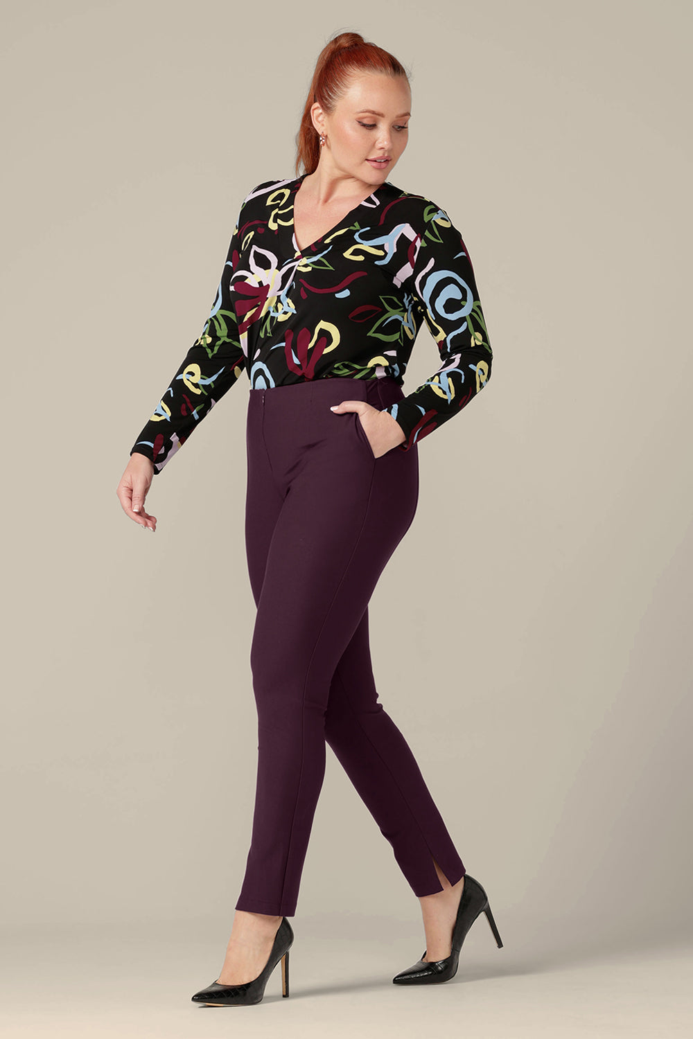 A size 12 woman wears mid-rise, slim leg pants in mulberry ponte jersey by Australia and New Zealand women's clothing label, L&F. Good workwear pants, these comfortable trousers are made for an inclusive size range of sizes 8 to 24.