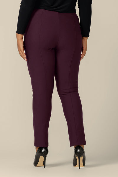 Back view of a size 18, fuller figure woman wearing slim leg pants in mulberry ponte jersey by Australia and New Zealand women's clothing brand, L&F. Good workwear pants, these quality trousers are made in Australia in inclusive sizes, 8 to 24.
