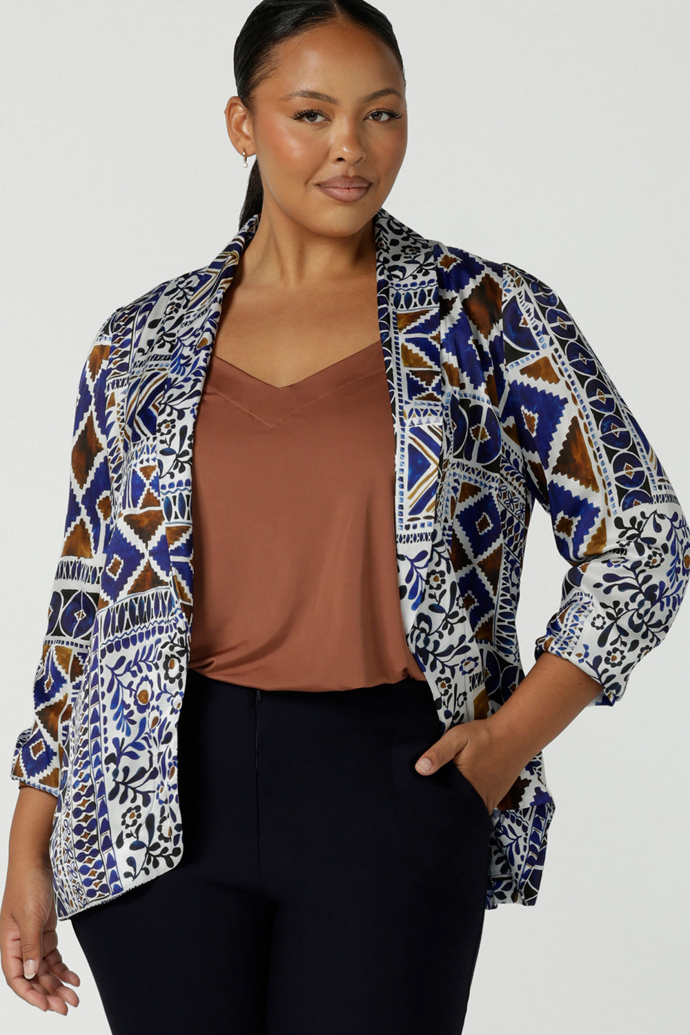 Curvy woman in a size 16 wears a soft tailored blazer in Italian Viscose fabric. A beautiful digital print tile design. Made in Australia for women size 8 - 24.
