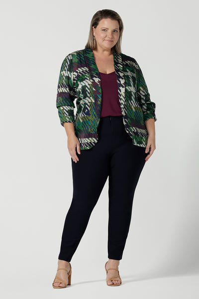 Size 18 Curvy woman wears a matching power suit in silk like fabric Italian Viscose. Tailored jacket and pants with soft tailoring details. Made in Australia for women size 8 - 24.