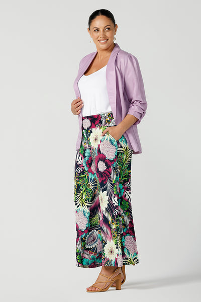 A size 12 curvy woman wears a linen blend blazer in lilac with a shawl collar. Soft tailoring details with shoulder tucks. Styled back with a Dany culotte in the Getaway print. Made in Australia size 8 - 24.