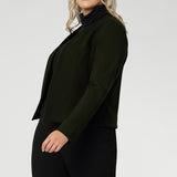 Tailored double-layer front panels add a sleek, sculpted look, while the single-layer back with subtle darts provides gentle shaping for a flattering fit. Full-length sleeves balance the cropped cut, enhancing its polished, minimalist aesthetic.