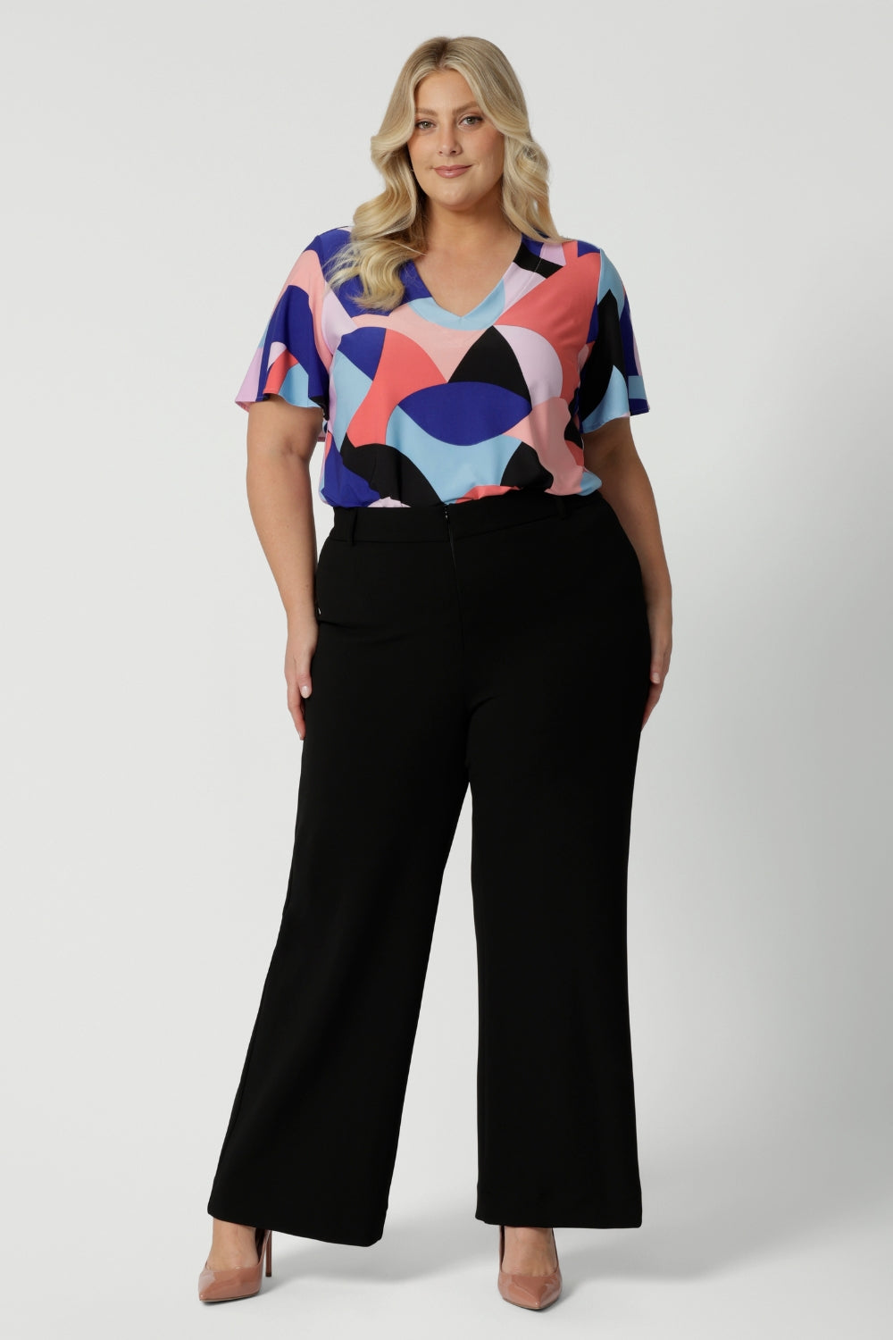 Plus sized model wears classic black pants. The perfect work wear and off-duty style. Made in Australia, these pants are made from easy care fabric. Designed with a focus on slow fashion, Leina & Fleur prioritize sustainability and timeless elegance, making them a staple for any wardrobe. These versatile black pants ensure you always look effortlessly chic and pair amazingly for any occasion. Sizes 8-24 available online now. 