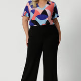 Plus sized model wears classic black pants. The perfect work wear and off-duty style. Made in Australia, these pants are made from easy care fabric. Designed with a focus on slow fashion, Leina & Fleur prioritize sustainability and timeless elegance, making them a staple for any wardrobe. These versatile black pants ensure you always look effortlessly chic and pair amazingly for any occasion. Sizes 8-24 available online now. 