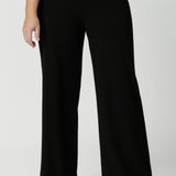 Close up image of size 12 model wearing easy care pants made of scuba crepe fabric that provide breathability and stretch around the body. The perfect work wear pant style, also has a matching blazer for a full suit look. Made in Australia for women sized 8 through to 24. 