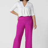 Size 10 Woman wears the Drew Pant in Fuchsia. A high waist tailored pant with matching suit blazer. Made in Australia for women size 8 - 24.