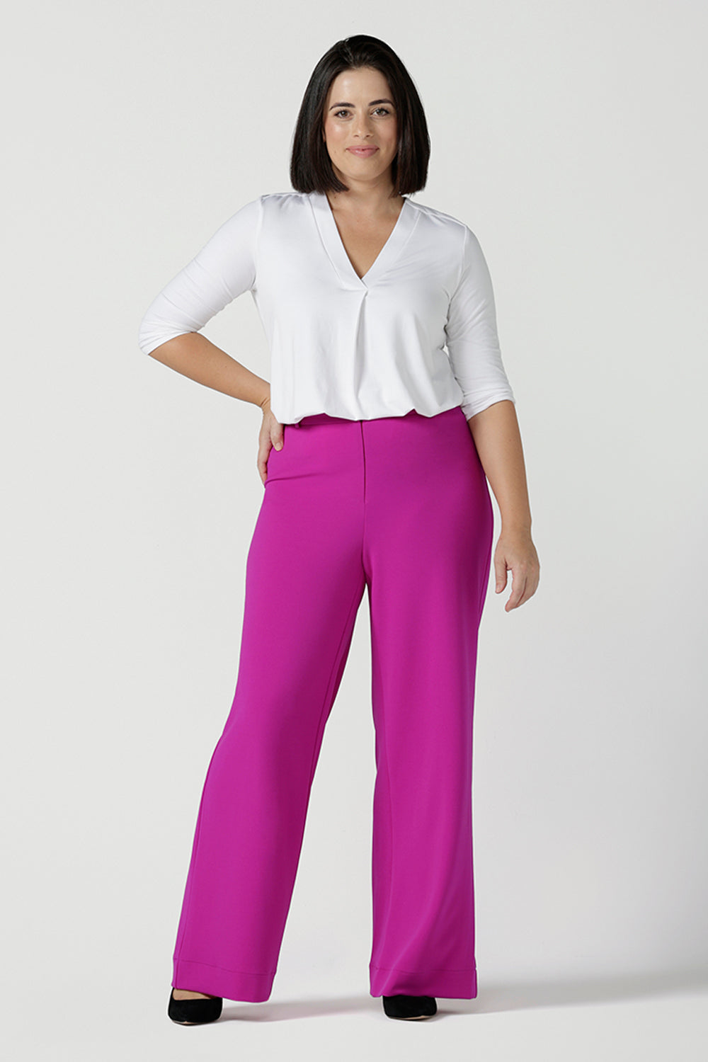 Size 10 Woman wears the Drew Pant in Fuchsia. A high waist tailored pant with matching suit blazer. Made in Australia for women size 8 - 24.