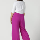 Back view of a size 10 Woman wears the Drew Pant in Fuchsia. A high waist tailored pant with matching suit blazer. Made in Australia for women size 8 - 24.