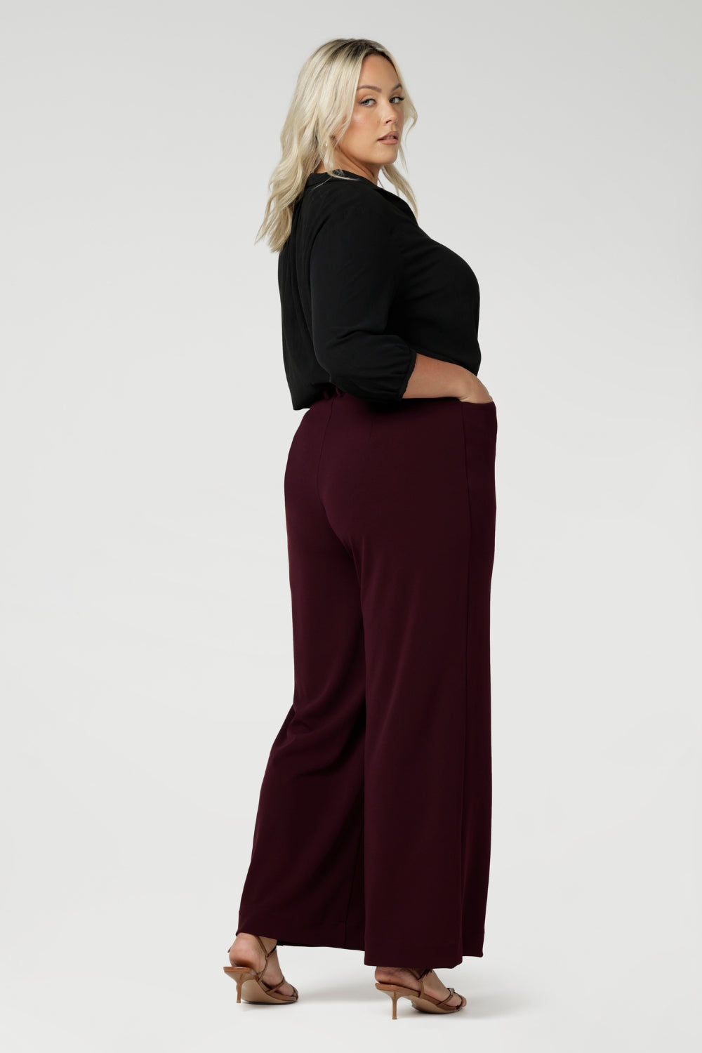 The pants feature straight-cut, wide legs for a modern, relaxed fit that flows beautifully from the waist down, offering a full-length look. Available in sizes 8-24, these pants are made by Leina & Fleur, a size-inclusive, Australian-made brand known for its high-quality craftsmanship and chic, versatile designs.