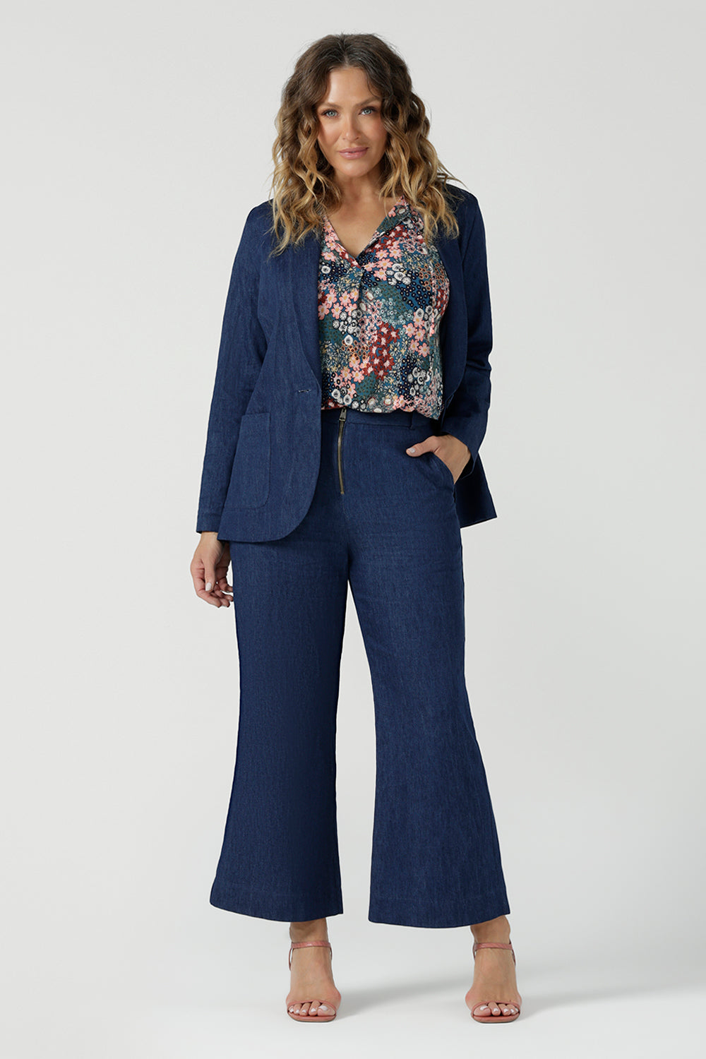A size 10 woman wears the Dutton Petite pant in Vintage Denim. A pentite friendly comfortable jean. Made in Australia for women petite to plus size 8-24. Styled back with a vintage denim blazer.