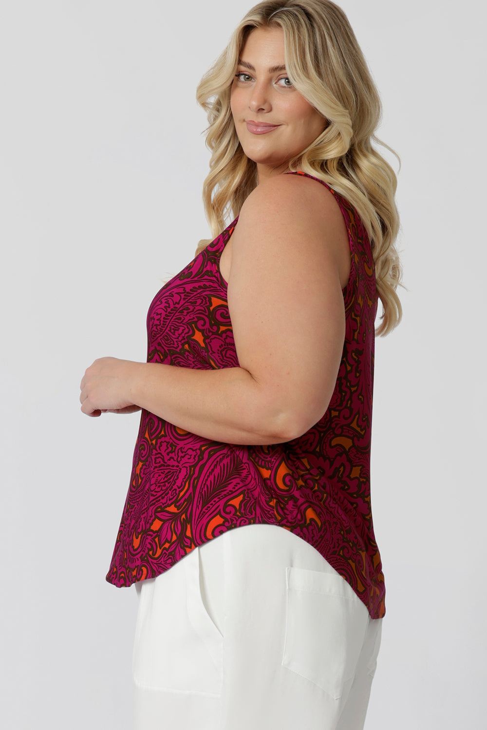 Close up side view of plus sized model wears paisley printed cami shows curved hemline feature that provides a flattering cut for fuller figures. Leina & Fleur proudly stock sizes 8-24 in this easy care cami.