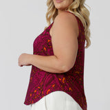 Close up side view of plus sized model wears paisley printed cami shows curved hemline feature that provides a flattering cut for fuller figures. Leina & Fleur proudly stock sizes 8-24 in this easy care cami.