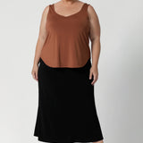 Size 18 model wears Eddy Cami in Clay, paired with midi skirt in black and black heels creating a summer event outfit.