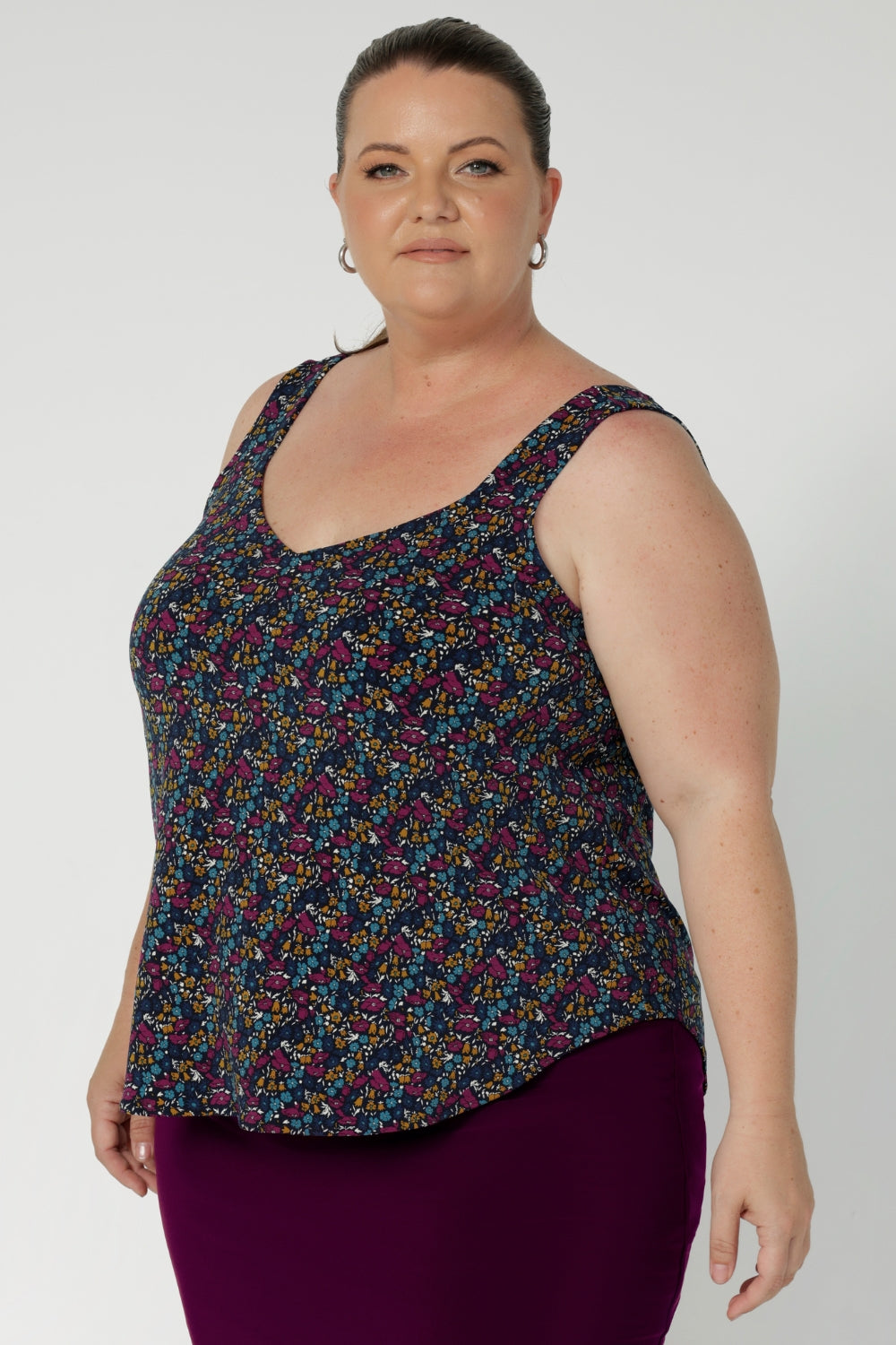 A delicate stitching detail around the neckline adds a subtle touch of texture, and the V-neck at the back gives it an extra dose of elegance. Summer Cami worn by plus sized woman with tube skirt to create an elevated summer outfit.