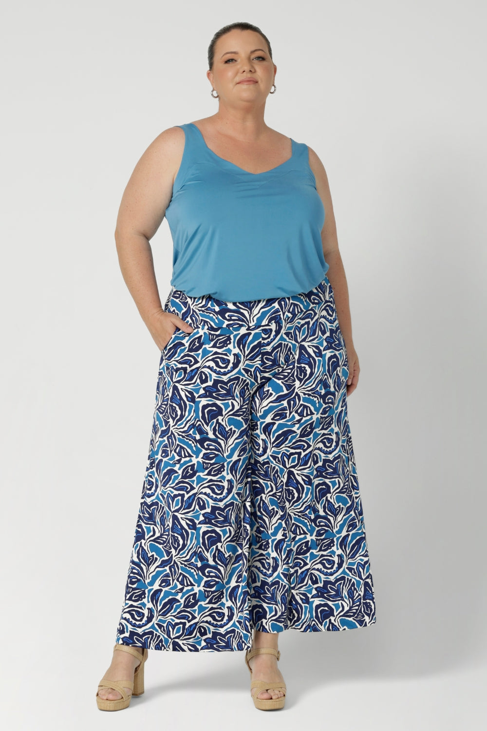 Over 40's woman wears the Eddy Cami top in Mineral. A curve friendly cami top with wide shoulder straps for bra strap coverage, paired with printed culotte pants. Made in Australia for women size 8 - 24.