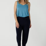 A size 10 woman wears a Navy Indi pant in jersey. A comfortable pant that is stylish and travel friendly. Made in Australia for women size 8-24. 