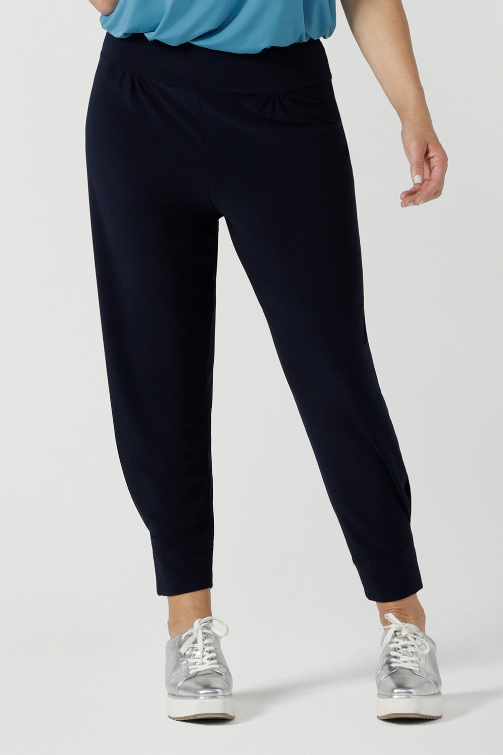 Close up of a size 10 woman wears a Navy Indi pant in jersey. A comfortable pant that is stylish and travel friendly. Made in Australia for women size 8-24. 