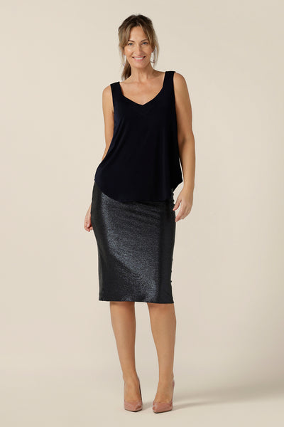 A glitzy skirt for cocktail and event wear, the Brooke Tube Skirt by Australian and New Zealand womenswear brand, L&F glitters in midnight blue shimmer jersey. A pull-on pencil skirt, the Brooke Tube Skirt's stretchy fabric makes for a comfortable eveningwear outfit, as shown here worn with a navy blue, slinky jersey camisole top. Shop this cocktail dress look in sizes 8 to 24.