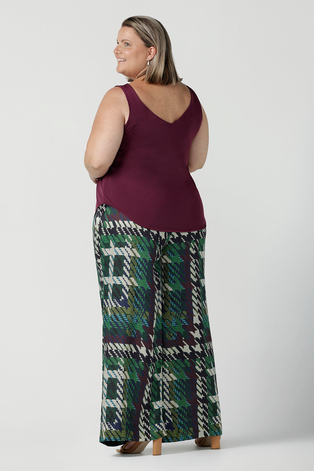 Back view of a size 18 Woman wears the Ellery Pant in Silky Italian Viscose. Size inclusive fashion. Tailored pants for work to event dressing. Made in Australia for women size 8 - 24.