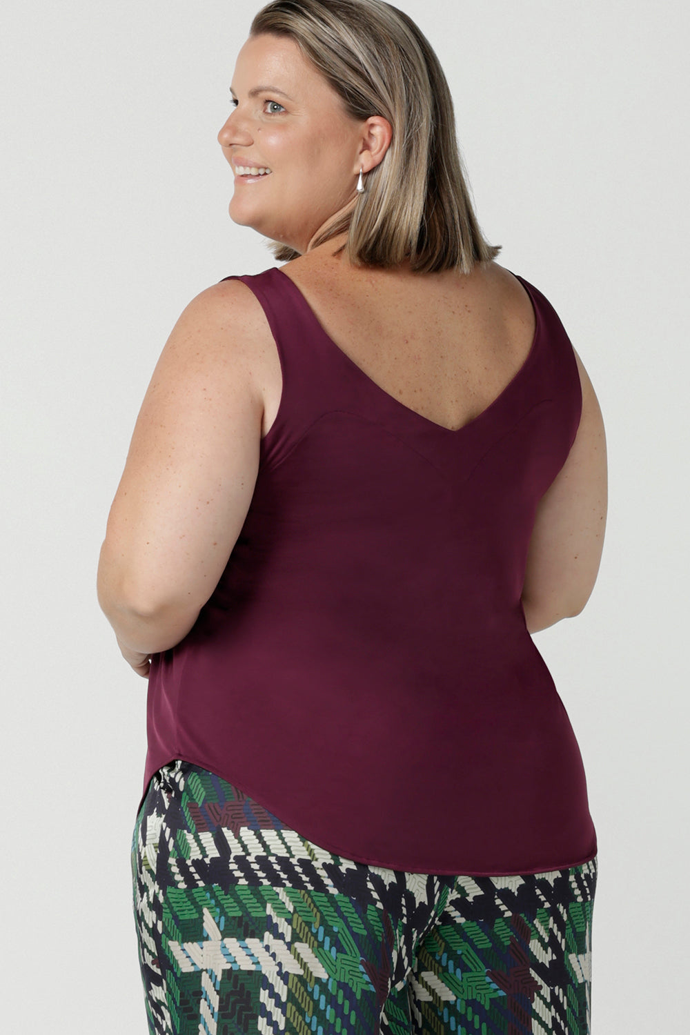 Back view of Amanda in s a size 18 in the Eddy Cami in plum. Made in Australia for women size 8 - 24. Styled back with the houndstooth Ellery pant. 