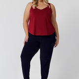 Plus sized woman wears red cami paired with travel friendly Indi Pant for a casual outfit. Made from high-quality slinky jersey fabric, it offers a luxurious feel while being an easy to care piece. This red cami is perfect for warmer weather to help cater to your summer celebrations. Proudly Australian made, this cami combines style and practicality, ensuring you stay cool and fashionable all season long. Leina & Fleur stock sizes 8-24.