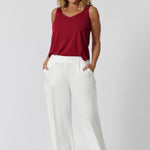 Over 40 year old woman wears light weight red cami made from high-quality slinky jersey fabric. Lightweight cami offers a luxurious feel while being an easy care piece. This red cami is perfect summer celebrations, ensuring you stay cool and fashionable all season long. Made in Australia by Leina & Fleur. Sizes 8-24.