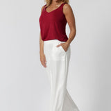 Over 40 year old woman wears light weight red cami made from high-quality slinky jersey fabric. Lightweight cami is paired with our Connor Pants in white for a summer ready casual outfit. This red cami has been designed for you to stay cool and fashionable all season long. Proudly made in Australia by Leina & Fleur brand, sizes 8-24.