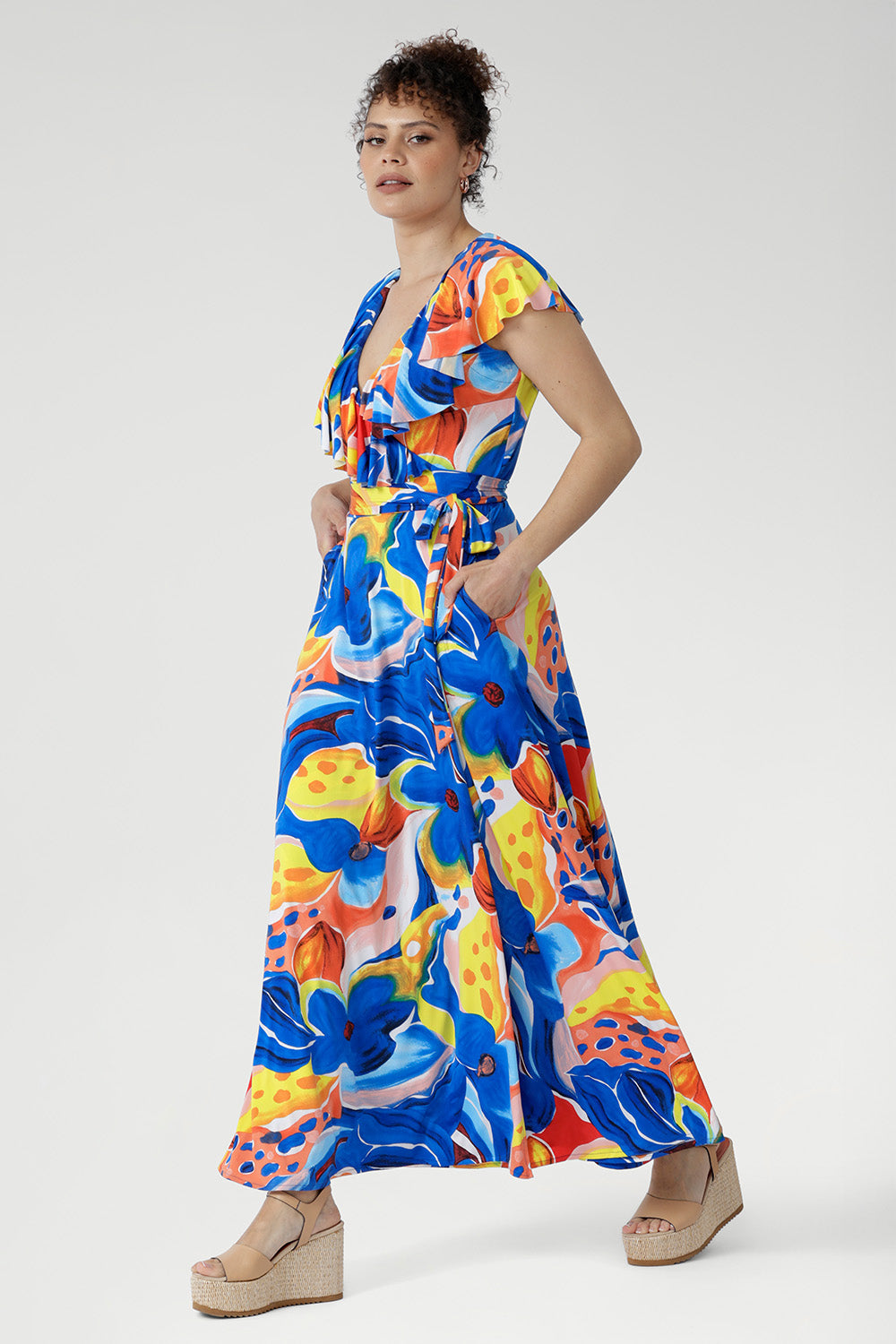 The Elle Maxi Wrap Dress in Summer Bliss is crafted from our cool-touch slinky jersey for a soft, breathable feel. A tie waist defines the silhouette, while the raw edge frill brings a light, feminine finish. With its vibrant abstract floral print and thoughtful details like pockets and a double-layered back, it’s the ultimate dress for summer celebrations and sunny escapes.