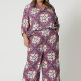 The pants come with a matching cami top, which is simple yet elegant, and a coordinating 3/4-sleeved top to complete the look. Both tops mirror the print of the pants, ensuring a cohesive ensemble. Available in sizes 8-24.