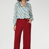 Long full-length sleeves with covered button cuffs and a flattering shirt-tail hemline — longer at the back — add versatility and ease to this pull-on style. Tuck detailing below the back neckline further elevates the design.