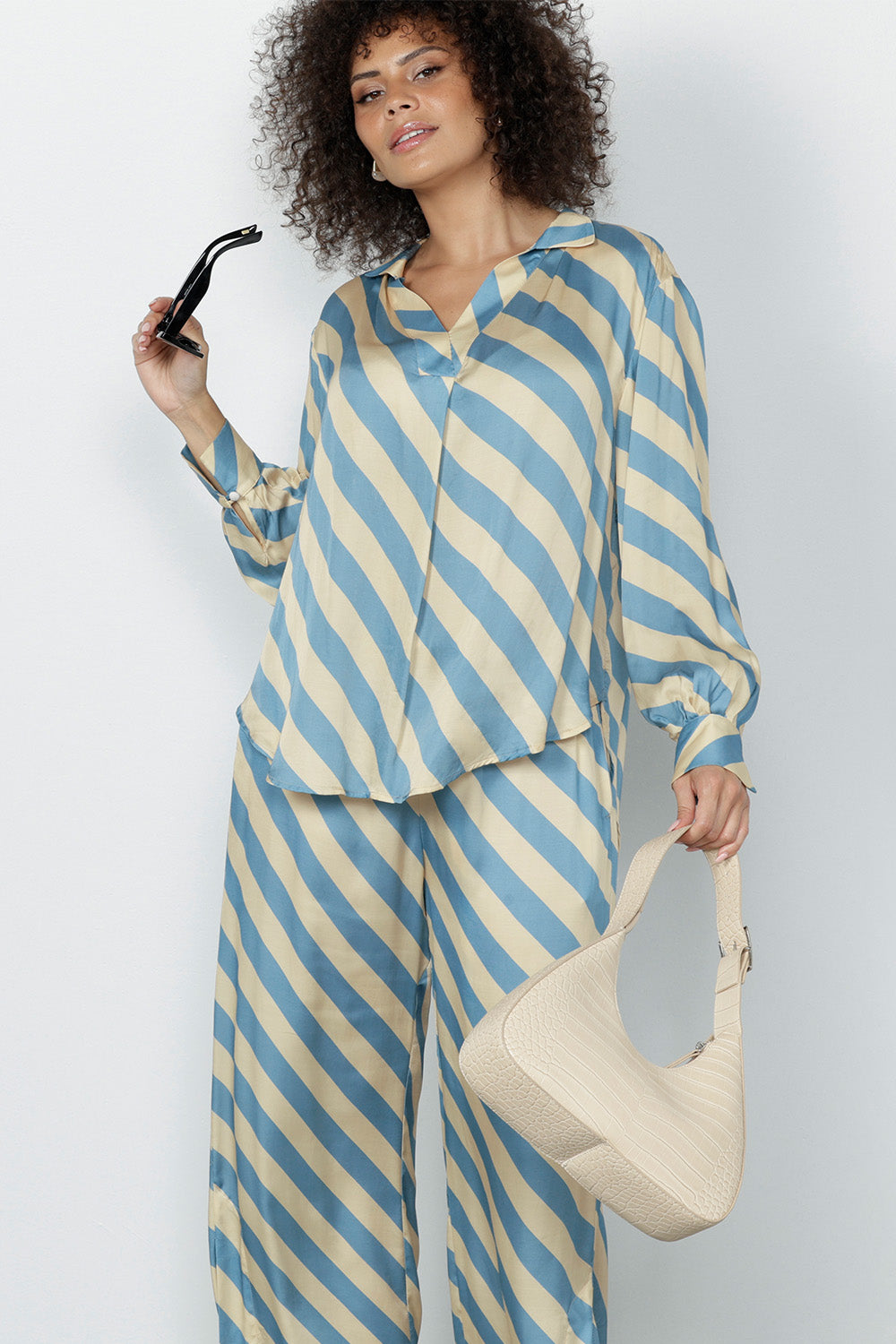 The sateen-weave fabric has a silky hand feel that drapes beautifully, making it ideal for warm-weather dressing.