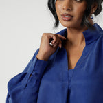 Workwear shirt features a collared V-neckline, cuffed sleeves and shirttail hemline that sits longer at the back. Made from suede touch Tencel fabric that has suede hand feel luxe drape. Available in sizes 8-24.le