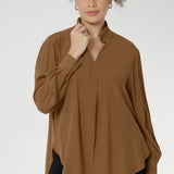 This is the Ellis Shirt in Nuthatch — an effortless piece with an oversized silhouette that’s made to move with you. Designed to be worn untucked or styled with a front or back tuck, it transitions seamlessly from relaxed to refined.