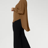 A collar neckline and soft V-neckline meet with a tailored tuck at the center, creating structure without compromising comfort. Subtle tuck details at the back neckline give added shape and a hint of detail from behind