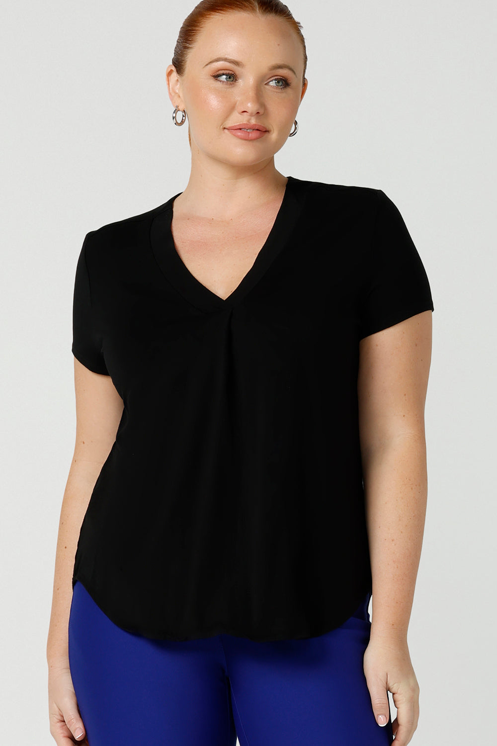 A good top for your capsule wardrobe, this V-neck top with short sleeves makes for a good office wear top for women, as well as a comfortable casual top. Shown on a size 12 woman, this top is made for curvy women by Australian women's clothing brand, Leina & Fleur. Shop black tops for women in sizes 8 to 24 in their online fashion boutique.