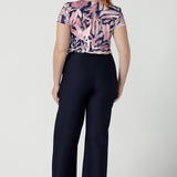 Size 12 woman wears a Emily top in Cantata with a navy base and pink brush strokes. V-neckline on a soft slinky jersey. Corporate casual top for women. Size 8 - 24.