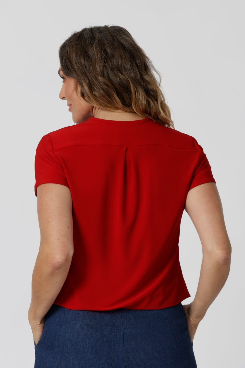 Back view of sleeved top red top. Crafted from dry touch jersey fabric to ensure a soft, dry breathable feel that is perfect for staying comfortable in the summer heat.  Top is made from easy-care fabric, making it an ideal piece for travel. Embrace summer with this vibrant and versatile piece. Shop now in sizes 8-24.