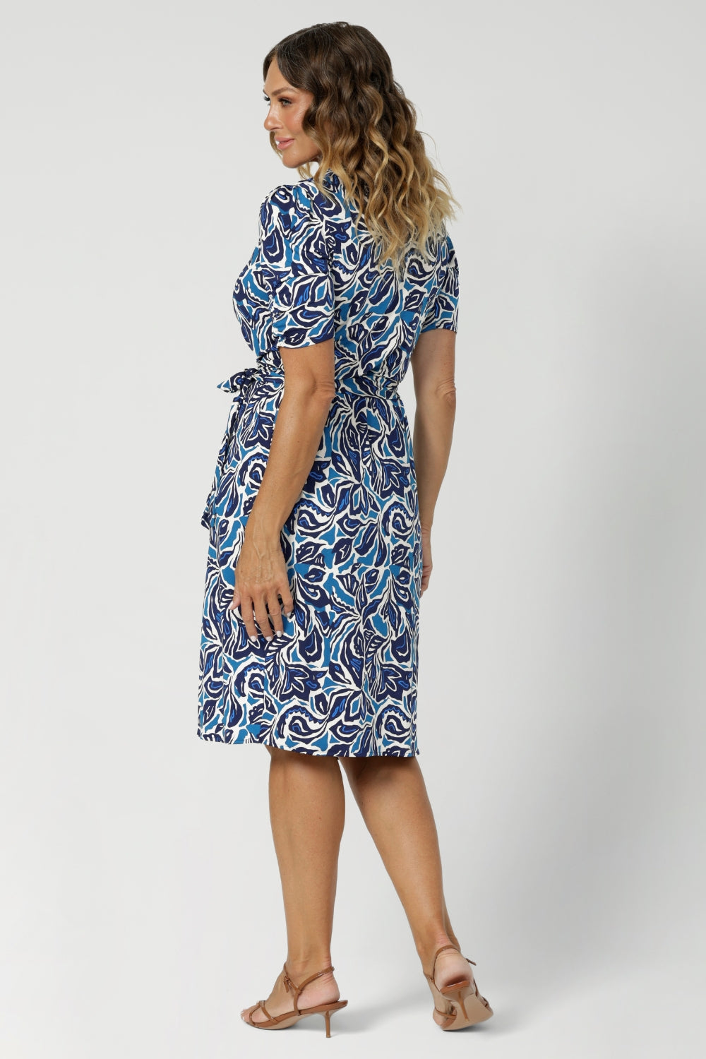 This wrap dress is as comfortable as it is flattering, draping beautifully over the body while offering ease of movement. The print, a sophisticated mix of white and varying shades of blue, adds a modern yet timeless feel, making it an ideal addition to any wardrobe. Available in size 8-24