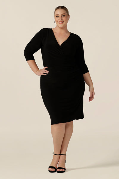 An elegant  black dress for evening and occasion wear, this is a fixed wrap, black jersey dress with 3/4. Worn by a plus size, size 18 woman, shop this made-in-Australia dress in sizes 8 to 24.
