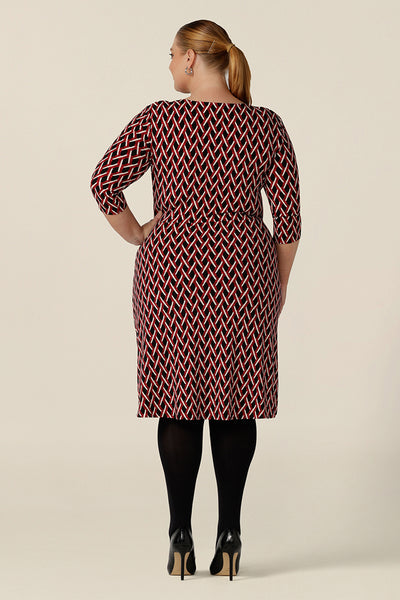 Back view of a plus size, size 18 woman wears a fitted wrap front dress with 3/4 sleeves by Australian fashion brand, Leina & Fleur. A good workwear dress, in printed jersey this is an easy-care dress for work wear capsule wardrobes.