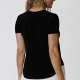 a tailored short sleeve black top with v-neckline and shirttail hemline, this summer top is a good top for off duty style.