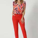 The pants are designed with angled front pockets, giving them a modern touch, while the back darts ensure a tailored fit that contours to the shape of the body. The tapered legs provide a sleek silhouette, and the ankle-length design adds a trendy, contemporary edge.