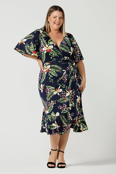A plus size wrap dress for curvy women in festive Merriment print. Jersey wrap dress in soft jersey fabric with frilly hem and sleeves. Made in Australia size 8 - 24. 
