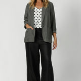 Over 40's model wears spotted cami paired with black work wear pants and heels and fern coloured blazer for an elevated workwear look. Australian made by clothing brand Leina & Fluer in inclusive sizing ranging from plus sized to petite in an 8-4.