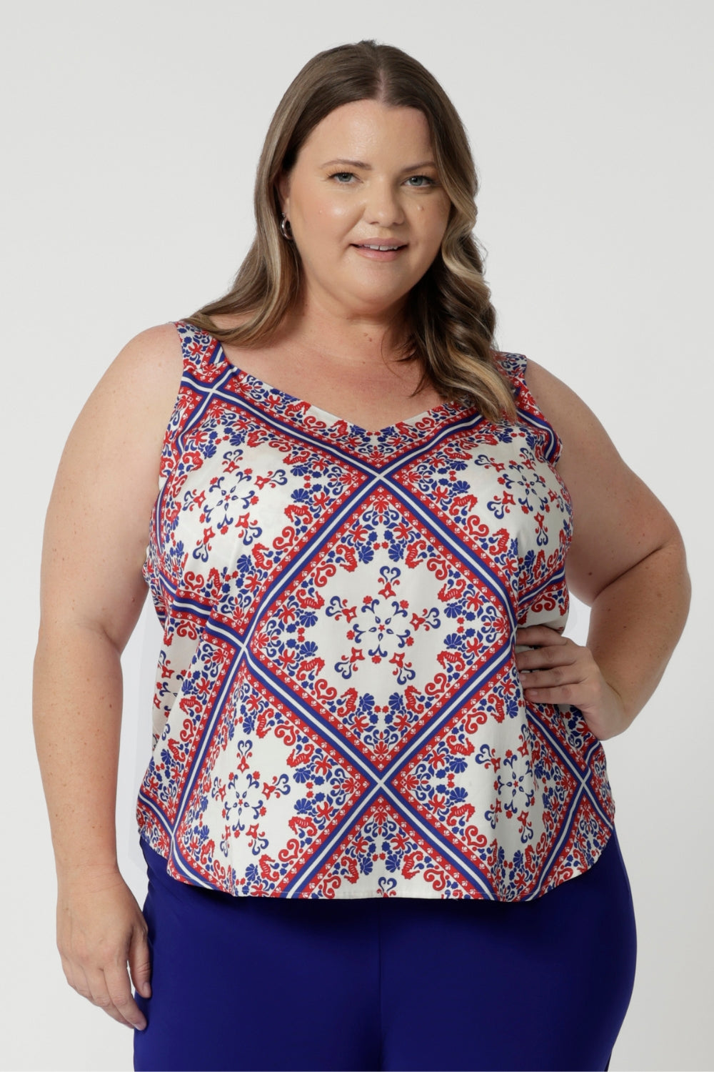 Cami features v neckline in both the front and back, as well as geometric pattern in shades of blue and red. Summer Cami provides contemporary flair to the otherwise minimalist design. The bold yet balanced print creates a sense of movement and depth, with sharp lines and subtle curves that stand out beautifully against the white background.